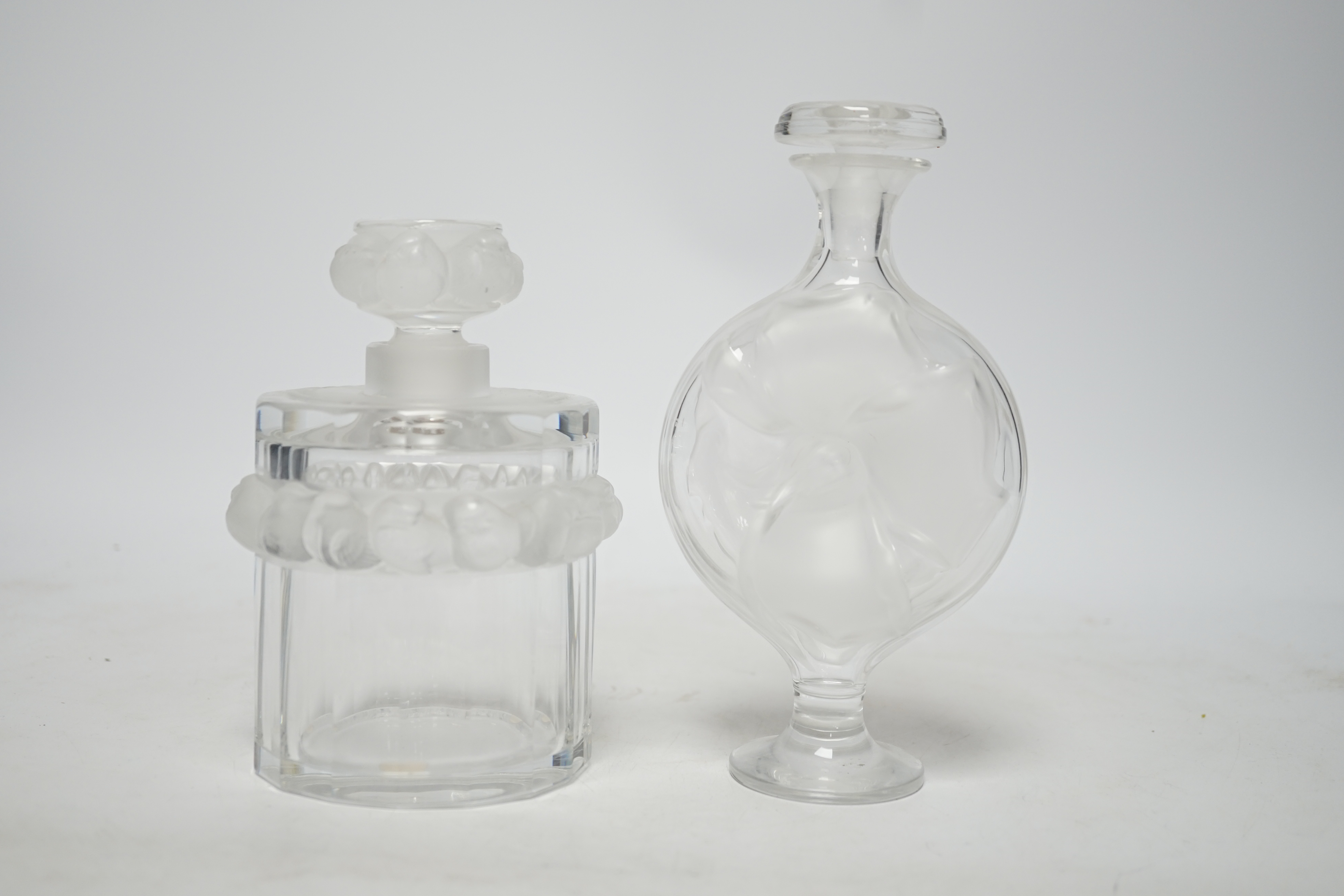 Two Lalique glass scent bottles and stoppers comprising ‘Robinson’ and ‘Moulin Rouge’, signed to the bases, largest 17cm high